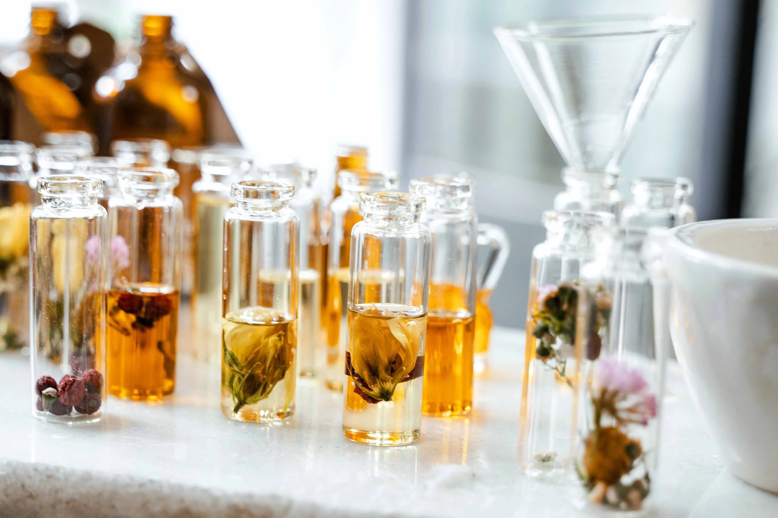 Hand-blended aromatherapy oils with botanicals in Diane's studio